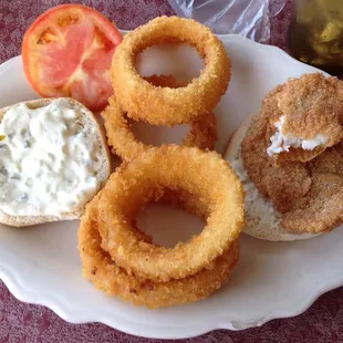 Very crunchy onion rings. Dry/hard bun. Empty drink glass. Off putting tomato, not red, not green, not good.