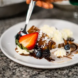 a plate of food with ice cream and berries