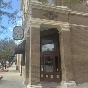 Front entrance of restaurant including original businesses logo over the archway.