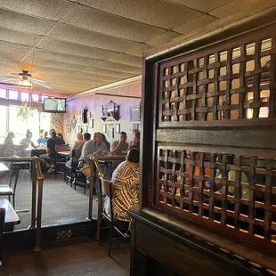 people sitting at tables in a restaurant