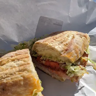 a sandwich with lettuce, tomato, and cheese