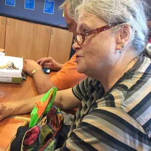 a woman sitting at a table using a laptop