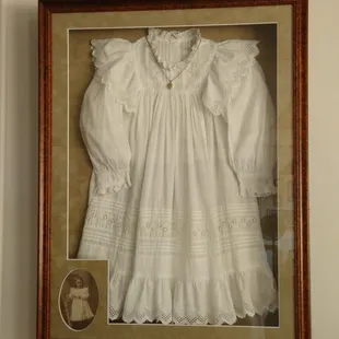 The dress was worn in 1899 when Grandmother was 3 years old.  The dress is displayed with the locket worn at the time...