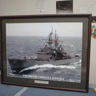This framing project depicts the ship that the customer's father was assigned for duty.  This was a Christmas present...
