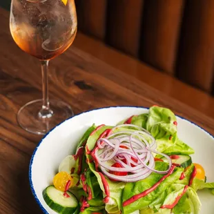 a plate of salad and a drink