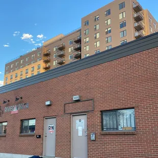a person laying on the ground in front of a brick building