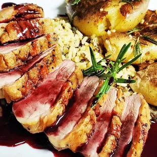 Pan Roasted Duck Breast drizzled over Wild Rice and served with Smashed Yukon Potatoes