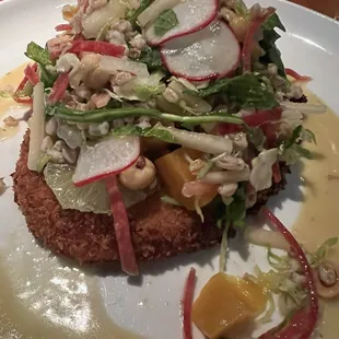 Chicken entree with beet salad atop.