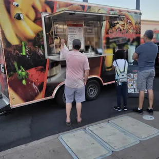 people ordering food from a food truck
