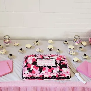 a cake and cupcakes on a table