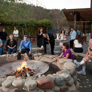 Fire pit area with buffet tables and bar in the background. Photos by http://davidkarnowski.com
