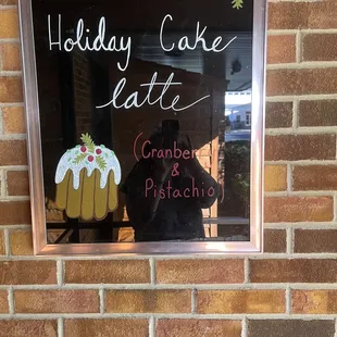 a reflection of a person taking a picture of a cake