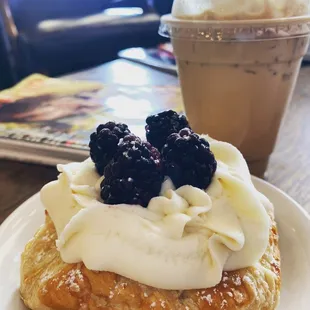 A super flakey and delicious creme filled pastry with creme cheese frosting and blackberries and a pumpkin marshmallow latte
