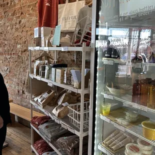 a woman standing in front of a refrigerator