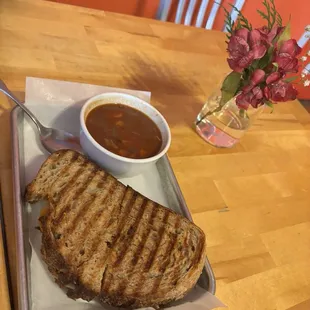 Homemade cup of chili with grilled cheese on artisan sourdough bread.