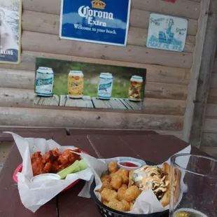 a beer and food on a picnic table