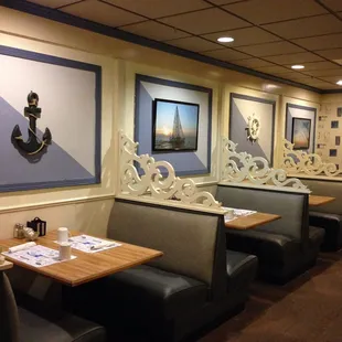 a row of booths with tables and chairs