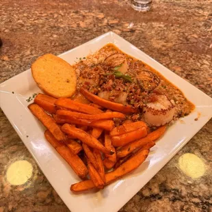 Scallops with a bacon sauce and sweet potato fries