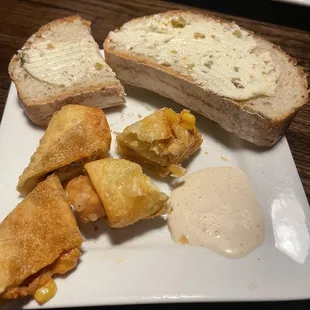 Spring rolls with ranch buffalo sauce and house bread. I cut my spring rolls in half to cool down for me.