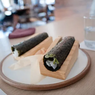 two sushi rolls on a plate