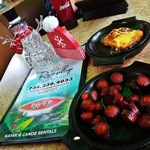 a plate of strawberries and a bowl of strawberries