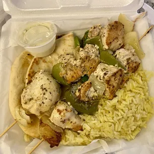 Chicken kabob with rice, grilled veggies and pita.