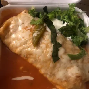 Asada burrito with extra salsa inside wrapped and topped with the wet red sauce
