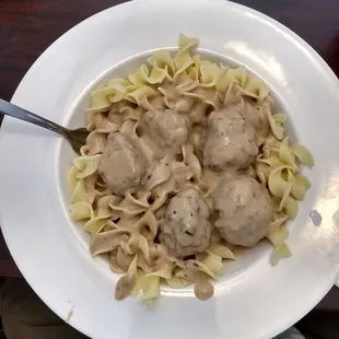 Handmade Swedish meatballs over noodles.