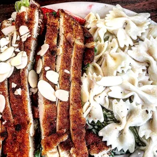 Almond crusted chicken salad with strawberry, mandarin and bow tie pasta. IG @minnie_munchies