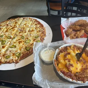 Pizza and breaded wings and cheese fries with bacon