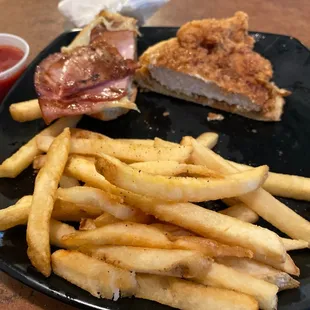 a plate of french fries and a sandwich