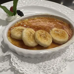 a bowl of dessert with bananas and berries