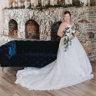 Bridal portrait at River's Edge in front of the triple hearth stone fireplace