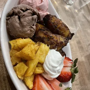 a plate of fruit and ice cream