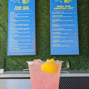 a pink drink with a lemon wedge