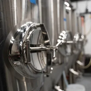 a row of stainless steel tanks