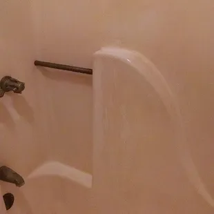 That's not imported Italian marble, those are streaks where some kind of cleaning product came in contact with the shower wall.