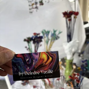 a person holding a business card