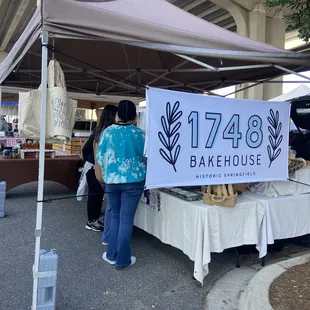 a woman standing under a tent