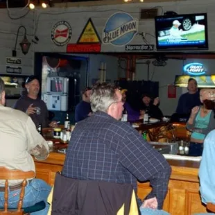 a group of people sitting at a bar