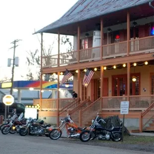 a row of motorcycles parked in front of a building