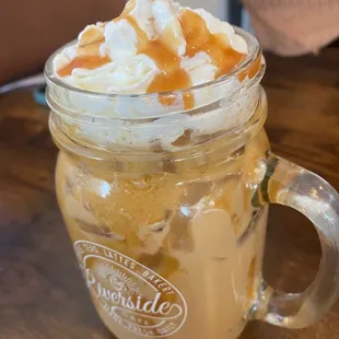 caramel and whipped cream in a mason jar