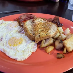Eggs, wheat toast bacon, potatoes.