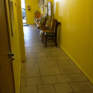 The long hallway to the bathrooms in back. Note the magazine racks.