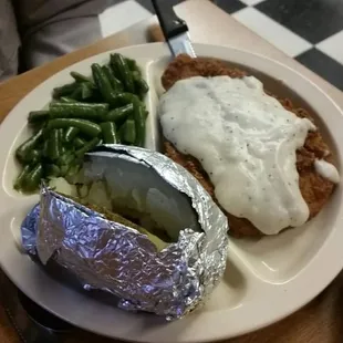 Chicken fried chicken, baked potato, green beans