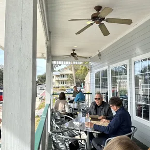 people sitting at a table outside
