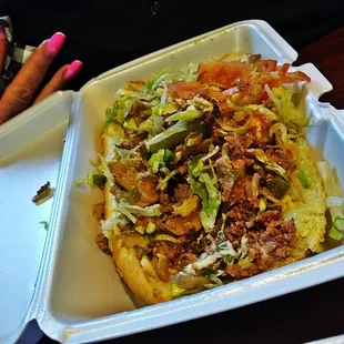 a hand reaching for a container of food