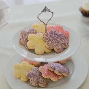 three tiered plates of decorated cookies