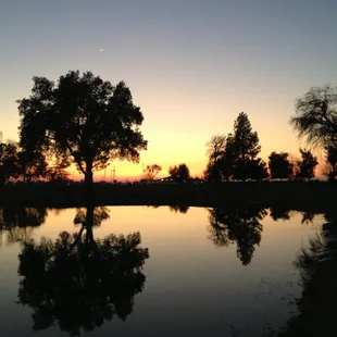 View of club house at dusk, across the pond.