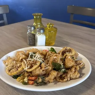 Riverside Grill Calamari- Fresh calamari with fried peperoncinis, Fresno chilis, spinach and lemon.